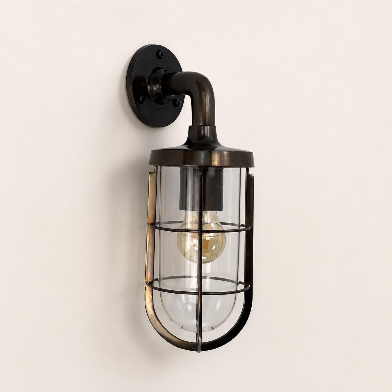 Runton antique brass caged swan-neck wall light with clear glass shade and Edison bulb